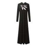Full-length black nightgown with long sleeves and a white bow motif with red center