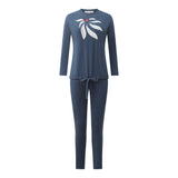 Blue two-piece pajama set with a long-sleeve top, tie-waist pants, and white bow print