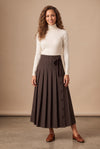 Dark brown pinstripe pleated maxi skirt, front buttons and tied waist detail, worn