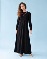 Black nursing nightgown with long sleeves, a full-length skirt and contrast trim at the neckline.