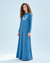 Blue long-sleeve nightgown with a white floral chest motif and red center, shown worn full length.