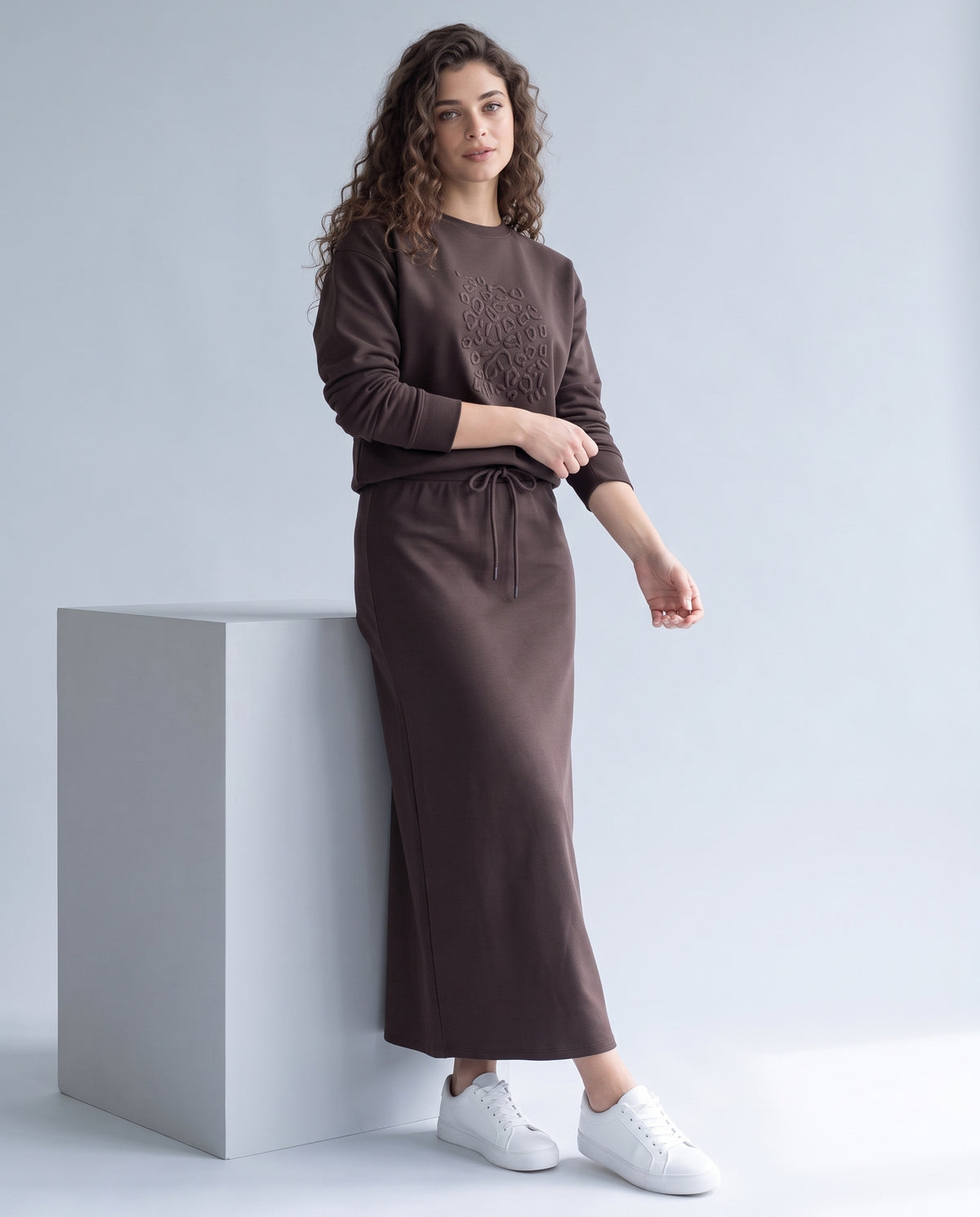 Brown embossed leopard print crewneck sweatshirt with long sleeves and drawstring waist tie.