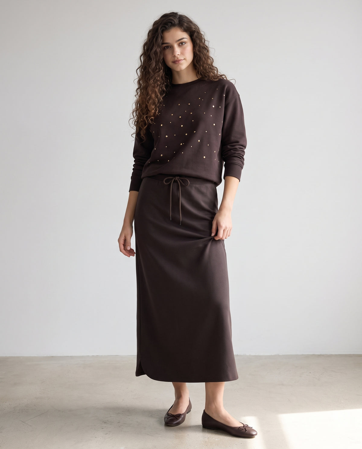 Dark brown crewneck sweatshirt with scattered rhinestones and ribbed hem, long sleeves