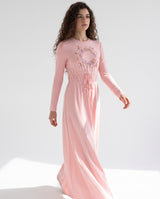 Long pink nightgown with floral chest medallion, gathered waist and floor-length flowing skirt