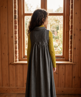 Gray sleeveless maxi dress for kids features button placket, pointy collar, tweed back insert and curve cut ruffled inverted empire waist.