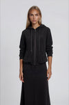 Black Terry Zip Hoodie with drawstring and pockets worn with black terry A-line midi skirt.
