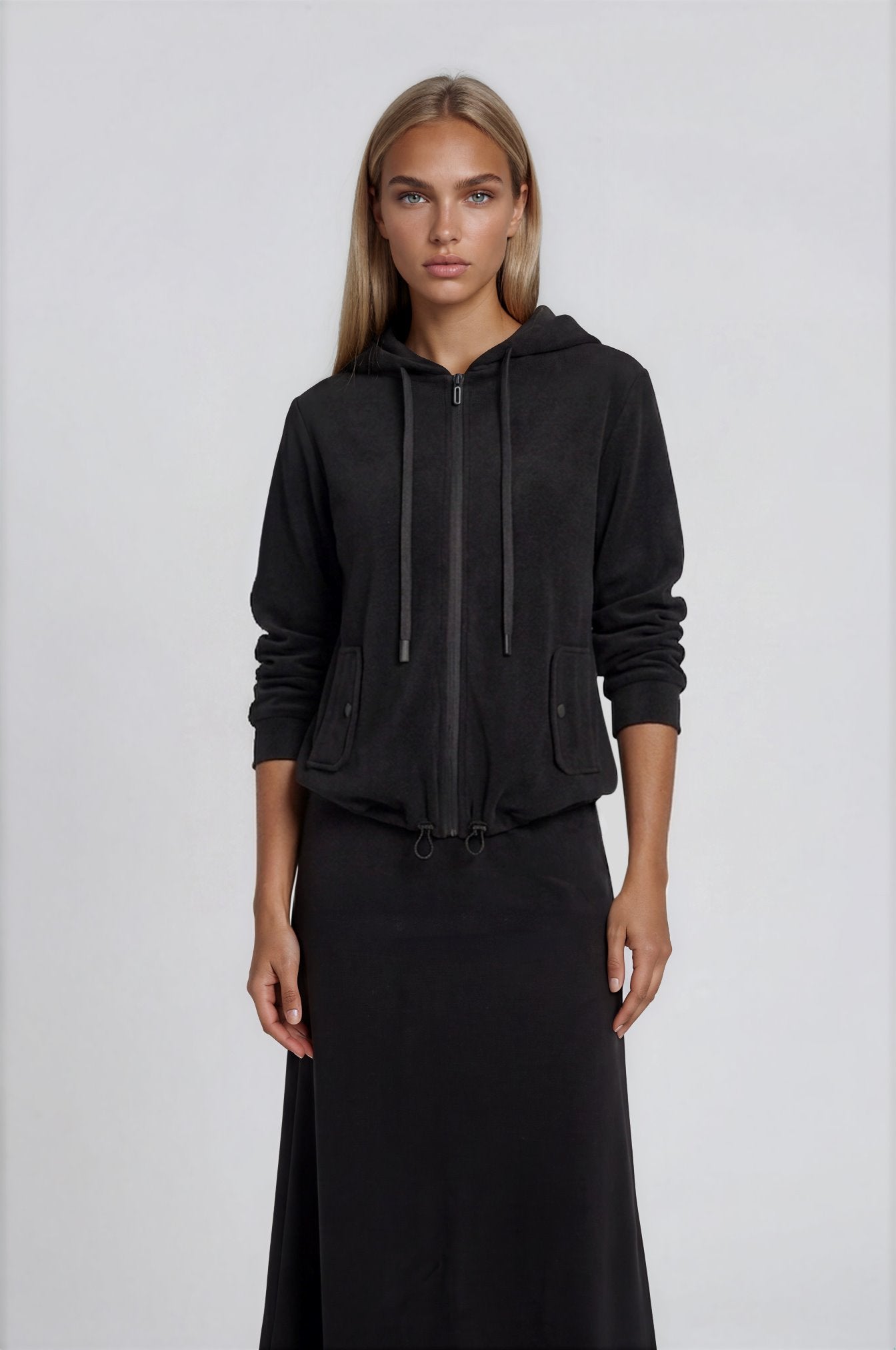 Black Terry Zip Hoodie with drawstring and pockets worn with black terry A-line midi skirt.