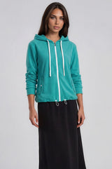 Dark Green Terry Zip Hoodie with drawstring and pockets worn with black terry A-line midi skirt.