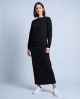 Black crewneck sweatshirt with long sleeves, ribbed cuffs, and monogram logo detail
