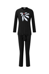 Black two-piece pajama set with a white bow print top and matching drawstring pants.