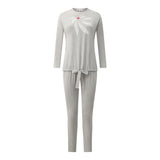 Grey pajama set displayed flat, with a long-sleeve top, drawstring pants and white bow print