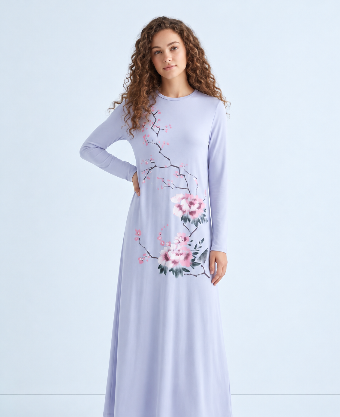 Model wearing a light blue floral nightgown with long sleeves and a flowing ankle-length skirt