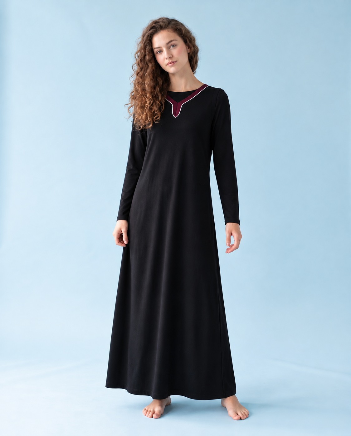 Black nursing nightgown with long sleeves, a full-length skirt and contrast trim at the neckline.