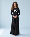 Black long-sleeve nightgown with a white bow motif and red center