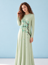 Pale green long-sleeve nightgown with a flowering tree print, shown worn