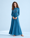 Model wearing a blue long-sleeve nightgown with floral medallion print and drawstring waist