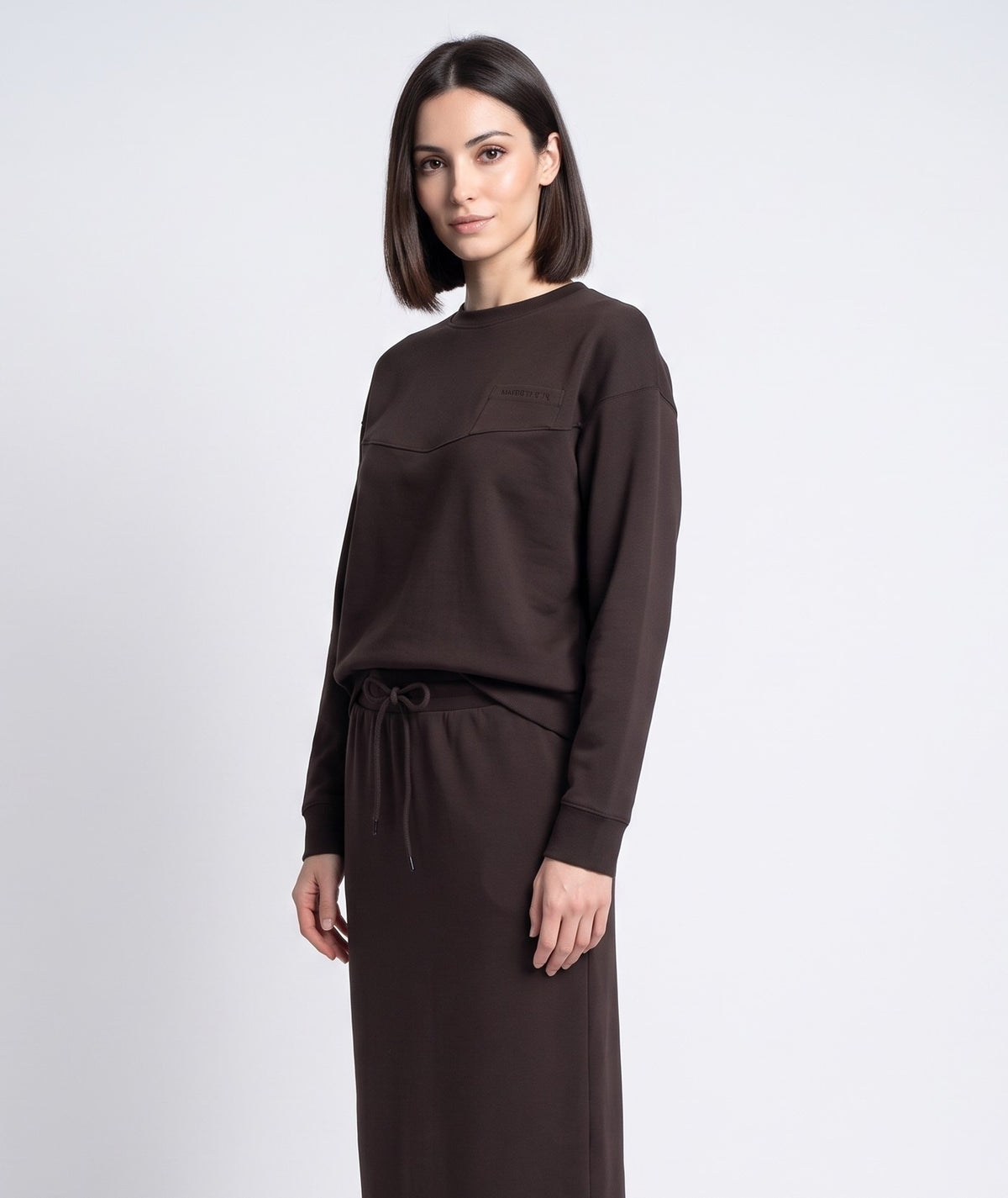 Brown crewneck sweatshirt with patch pocket and tie-front drawstring hem