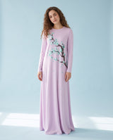 Model wearing a light purple long-sleeve nightgown with a flowering branch print