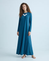 Model wearing a blue nursing nightgown with long sleeves and white V-neck trim